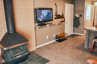 a living room with a fireplace and a tv at Fawn Valley Inn- 284 condo in Estes Park