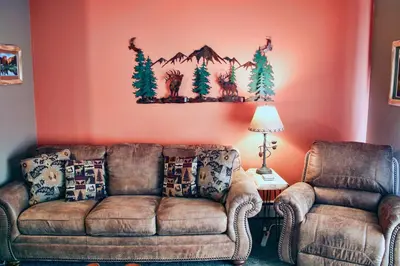a living room with a couch and two chairs at Fawn Valley Inn- 284 condo in Estes Park