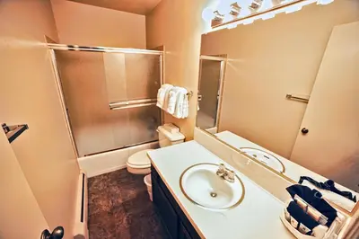 a bathroom with a sink and a toilet and a mirror at Fawn Valley Inn- 284 condo in Estes Park