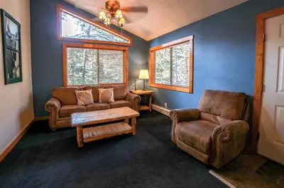 a living room with two chairs and a couch at Timber Creek Chalets- 9 chalet in Estes Park
