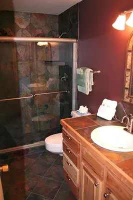 a bathroom with a shower and a sink and a toilet at Fawn Valley Inn- 280 condo in Estes Park