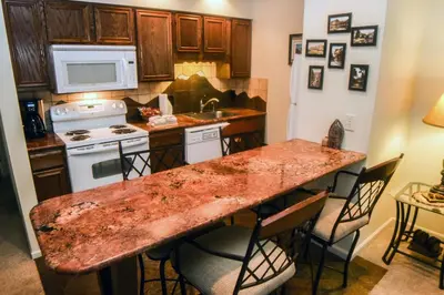 a kitchen with a marble counter top and a stove at Fawn Valley Inn- 292 apts in Estes Park