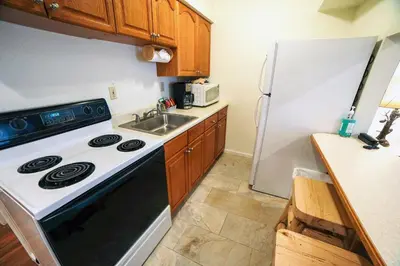 a kitchen with a stove and a sink and a refrigerator at Fawn Valley Inn- 295 condo in Estes Park