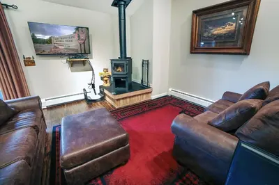 a living room with a couch and a stove at Fawn Valley Inn- 210 condo in Estes Park