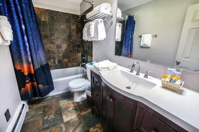 a bathroom with a sink and a toilet and a tub at Fawn Valley Inn- 210 condo in Estes Park