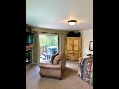 a living room with a couch and a fireplace at Fawn Valley Inn- 255 condo in Estes Park