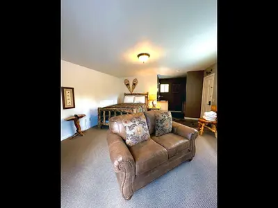 a living room with a couch and a bed at Fawn Valley Inn- 255 condo in Estes Park