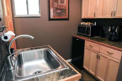 a kitchen with a sink and a microwave at Fawn Valley Inn- 255 condo in Estes Park