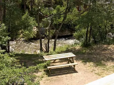 a wooden bench sitting in the middle of a park at Fawn Valley Inn- 255 condo in Estes Park