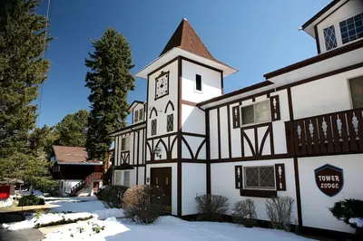 a building with a clock tower in the snow at Fawn Valley Inn- 255 condo in Estes Park