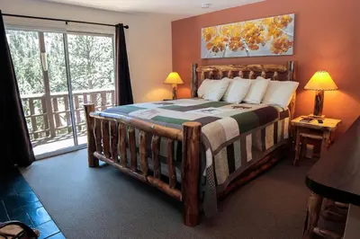 a bedroom with a bed and a large window at Fawn Valley Inn- 278 condo in Estes Park