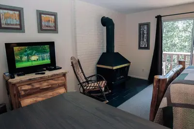 a living room with a fireplace and a television at Fawn Valley Inn- 278 condo in Estes Park