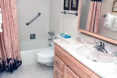 a bathroom with a sink and a toilet and a mirror at Fawn Valley Inn- 278 condo in Estes Park