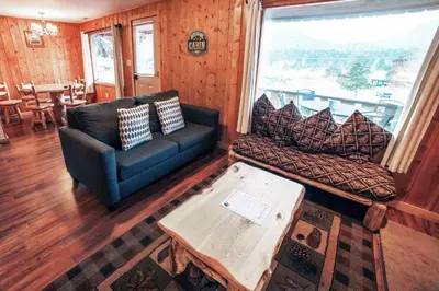 a living room with a couch and a table at Lazy R Cottages- 8 cabin in Estes Park