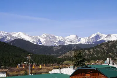 a mountain range with snow covered mountains in the distance at Lazy R Cottages- 8 cabin in Estes Park