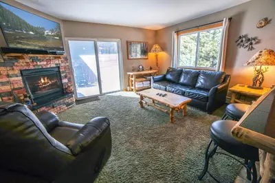 a living room with a couch and a fireplace at Fawn Valley Inn- 306 apts in Estes Park