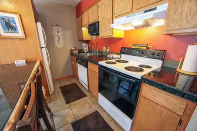 a kitchen with a stove and a white stove top oven at Fawn Valley Inn- 306 apts in Estes Park