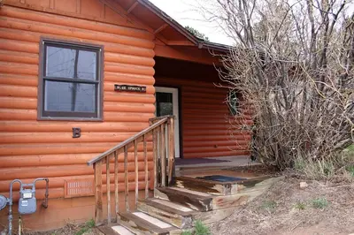 a staircase leading to the door of a cabin at Lazy R Cottages- 7B cottage in Estes Park