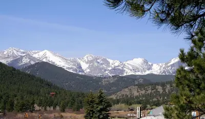 a mountain range with snow capped mountains in the distance at Lazy R Cottages- 7B cottage in Estes Park