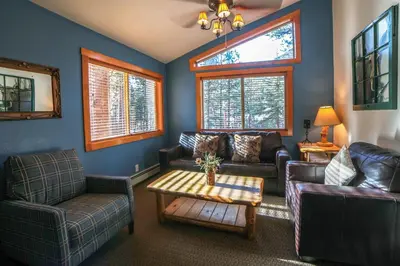a living room with couches and a coffee table at Timber Creek Chalets- 8 chalet in Estes Park