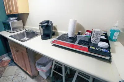 a kitchen counter with a coffee maker and a microwave at Fawn Valley Inn- 107 condo in Estes Park