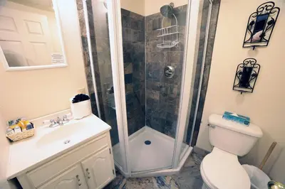 a bathroom with a shower and a toilet and a sink at Fawn Valley Inn- 107 condo in Estes Park