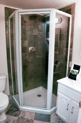 a shower with a glass door in a bathroom at Fawn Valley Inn- 103 condo in Estes Park