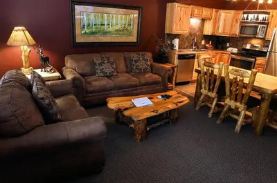 a living room with a couch and a table at Fawn Valley Inn- 277 condo in Estes Park