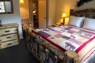 a bedroom with a bed with a quilt on it at Fawn Valley Inn- 277 condo in Estes Park