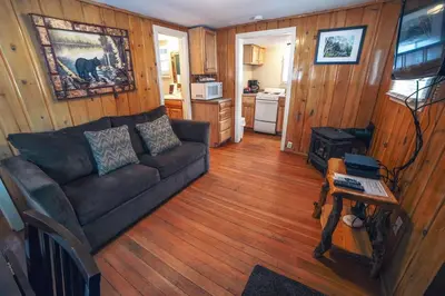 a living room with a couch and a table at Triple R Cottages- 3 cabin in Estes Park