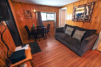 a living room with a couch and a table at Triple R Cottages- 3 cabin in Estes Park