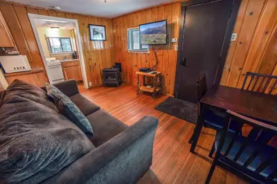 a living room with a couch and a piano at Triple R Cottages- 3 cabin in Estes Park