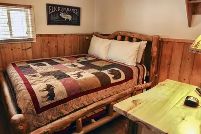a bedroom with a bed with a quilt on it at Triple R Cottages- 3 cabin in Estes Park