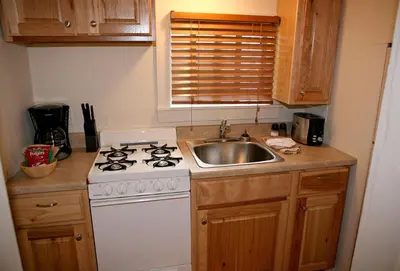 a kitchen with a white stove and a sink at Triple R Cottages- 3 cabin in Estes Park