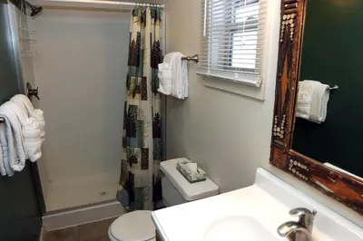 a bathroom with a sink and a toilet and a mirror at Triple R Cottages- 3 cabin in Estes Park