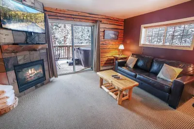 a living room with a couch and a fireplace at Fawn Valley Inn- 300 condo in Estes Park