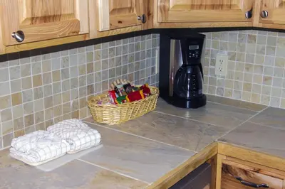 a kitchen counter with a basket and towels on the counter at Fawn Valley Inn- 300 condo in Estes Park
