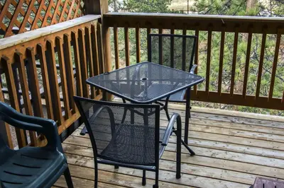 a patio table and chairs on a deck at Fawn Valley Inn- 300 condo in Estes Park