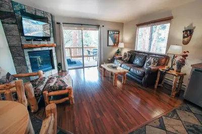 a living room with a couch and a fireplace at Fawn Valley Inn- 267 condo in Estes Park