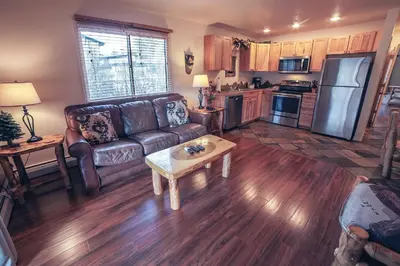 a living room with a couch and a table at Fawn Valley Inn- 267 condo in Estes Park