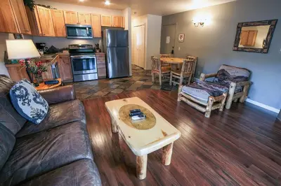 a living room with a couch and a table at Fawn Valley Inn- 267 condo in Estes Park