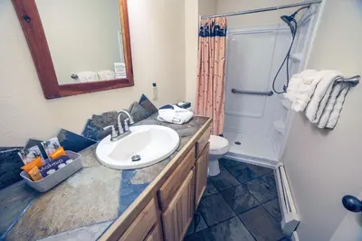 a bathroom with a sink and a shower and a toilet at Fawn Valley Inn- 267 condo in Estes Park