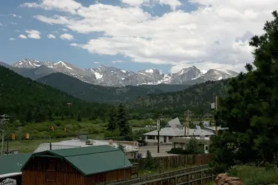 a mountain range with snow capped mountains in the distance at Lazy R Cottages- 15 cabin in Estes Park