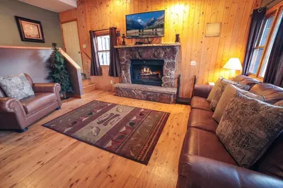 a living room with a couch and a fireplace at Lazy R Cottages- 15 cabin in Estes Park