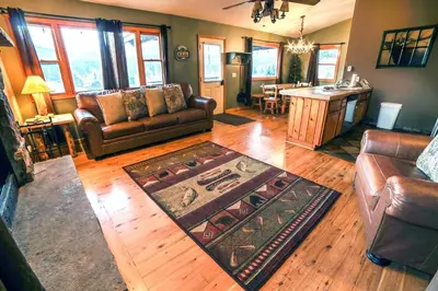 a living room with a couch and a table at Lazy R Cottages- 15 cabin in Estes Park
