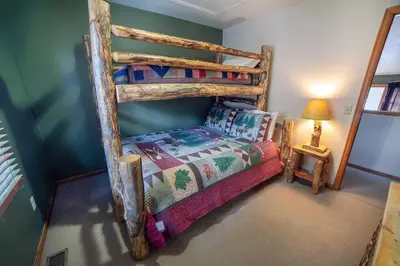 a bedroom with a wooden bunk bed in a room at Lazy R Cottages- 15 cabin in Estes Park