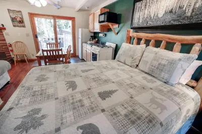 a bedroom with a bed with a quilt on it at Sunnyside Knoll- 11 apts in Estes Park