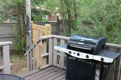 a grill sitting on top of a wooden deck at Sunnyside Knoll- 11 apts in Estes Park