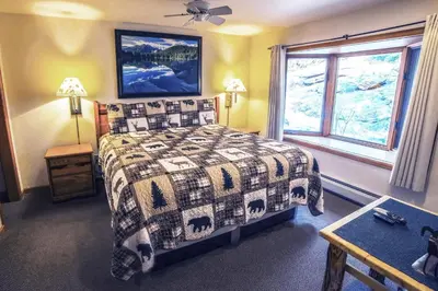 a bedroom with a bed and a window at Sunnyside Knoll- 16 cabin in Estes Park