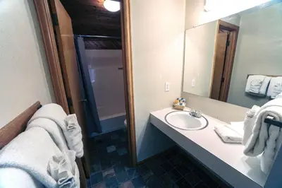 a bathroom with a sink and a mirror at Sunnyside Knoll- 16 cabin in Estes Park
